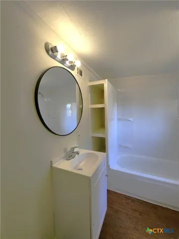 a bathroom with a sink a toilet and a bathtub