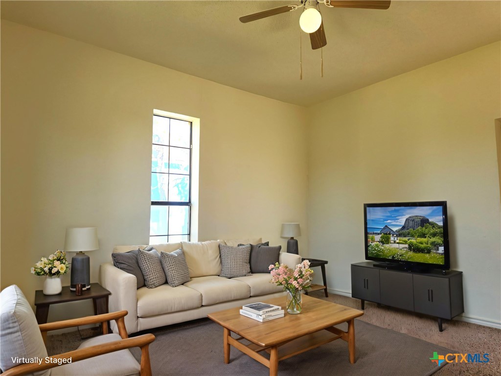 209 South 27th Street Temple, TX 76504 - Photo 4 of 26 a living room with furniture and a flat screen tv