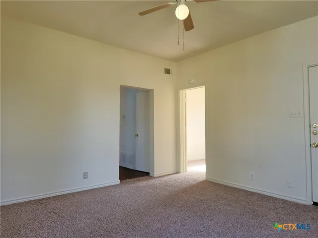 a view of an empty room and a window