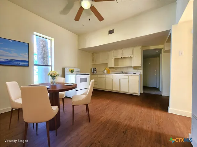 a view of a dining room with furniture and wooden floor