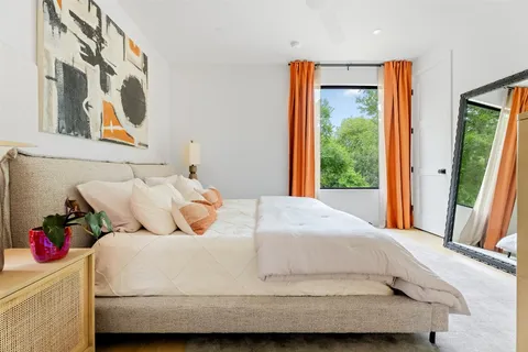 a bedroom with a large bed and a large window