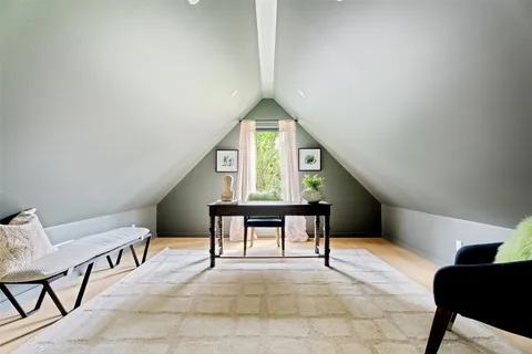 a bed room with a bed and a chair