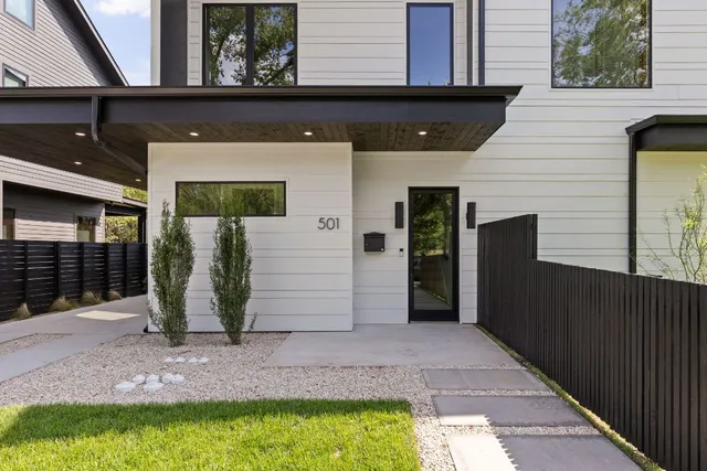 a kitchen with stainless steel appliances granite countertop a stove a sink dishwasher a refrigerator and a fireplace