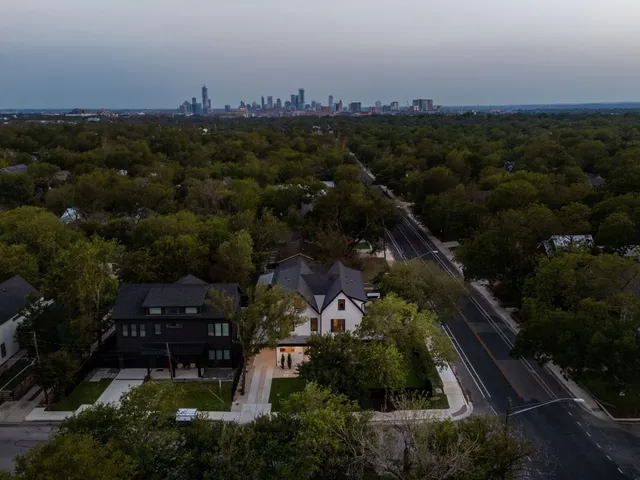 an aerial view of a house with a yard