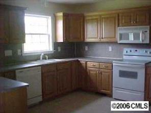 2180 River Road Woodleaf, NC 27054 - Photo 5 of 7 a kitchen with stainless steel appliances granite countertop a sink stove and cabinets