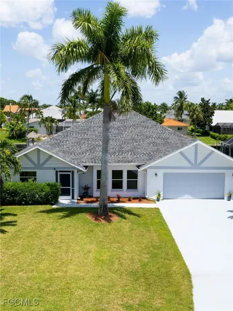a house view with swimming pool and trees in the background