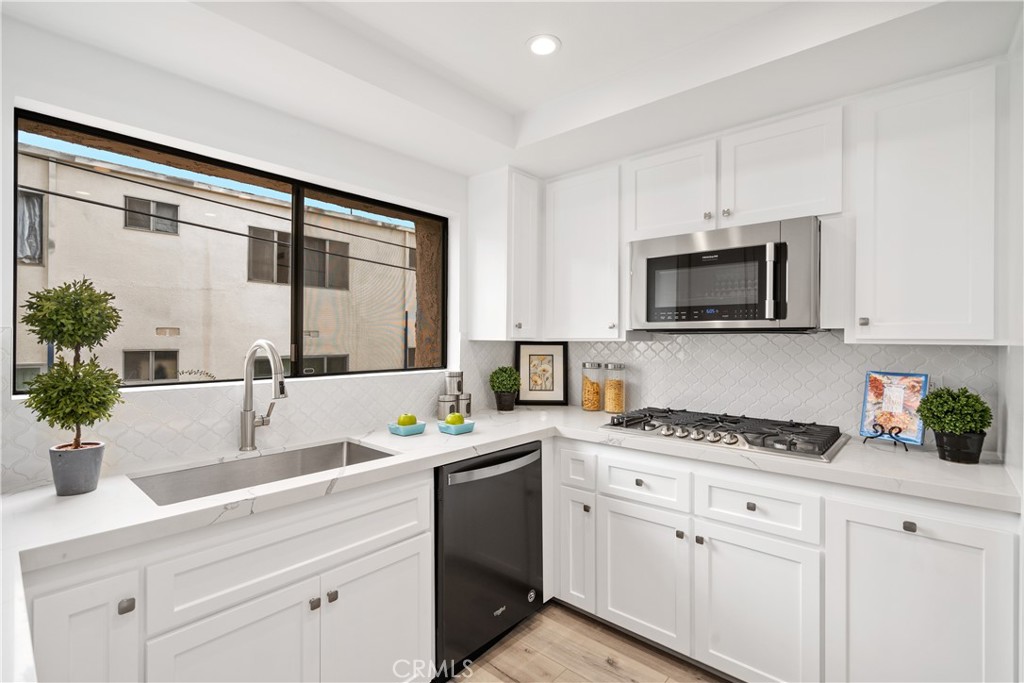 435 Fairview Avenue, Unit 7 Arcadia, CA 91007 - Photo 11 of 35 a kitchen with a sink stove top oven and microwave