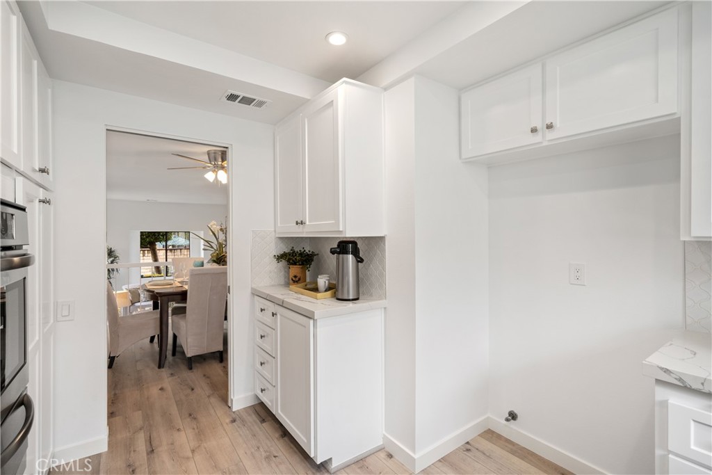 435 Fairview Avenue, Unit 7 Arcadia, CA 91007 - Photo 12 of 35 a kitchen with white cabinets and white appliances