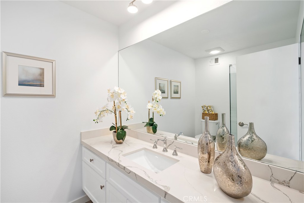 435 Fairview Avenue, Unit 7 Arcadia, CA 91007 - Photo 21 of 35 a bathroom with a granite countertop sink and a mirror