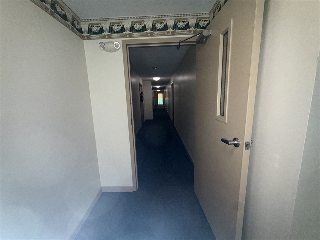 176 Maple Avenue, Unit 131 Rutland, MA 01543 - Photo 10 of 16 a view of a hallway with a wooden door