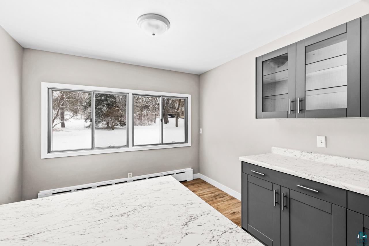 3754 Carlton Street Barnum, MN 55707 - Photo 16 of 52 Bedroom with a baseboard heating unit and light wood finished floors