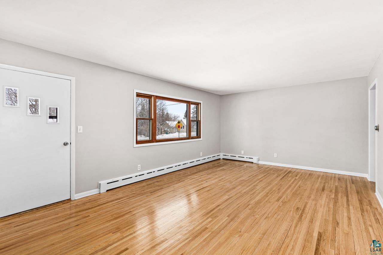 3754 Carlton Street Barnum, MN 55707 - Photo 25 of 52 Entryway with light wood-style flooring and a baseboard heating unit