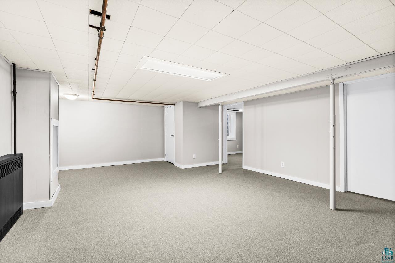 3754 Carlton Street Barnum, MN 55707 - Photo 30 of 52 Finished basement with light carpet and baseboards