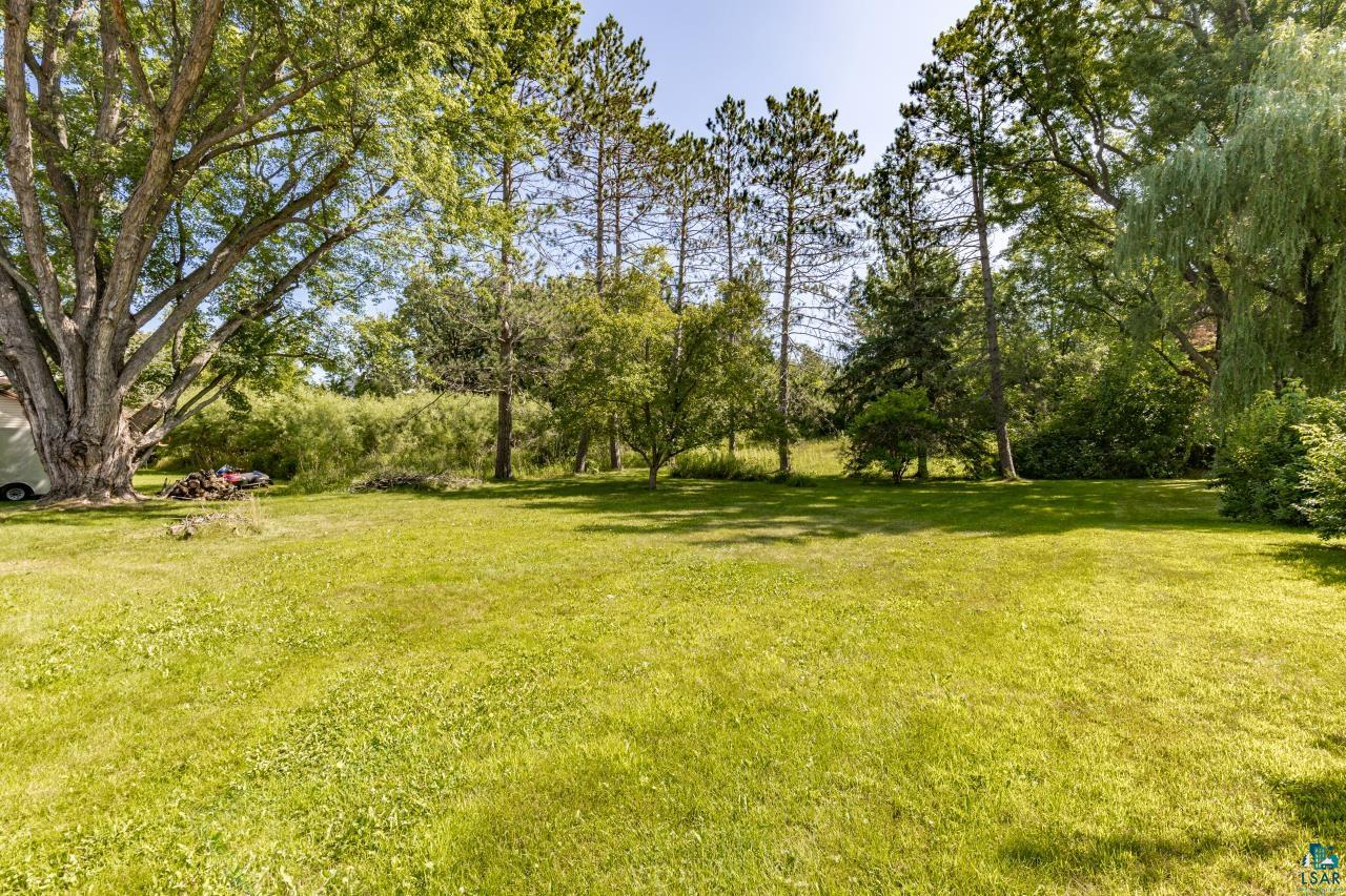 3754 Carlton Street Barnum, MN 55707 - Photo 3 of 52 View of grassy yard with view of scattered trees