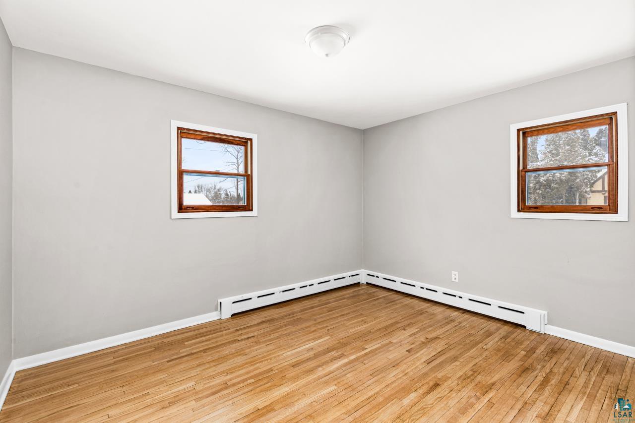 3754 Carlton Street Barnum, MN 55707 - Photo 39 of 52 Empty room with light wood finished floors and baseboard heating