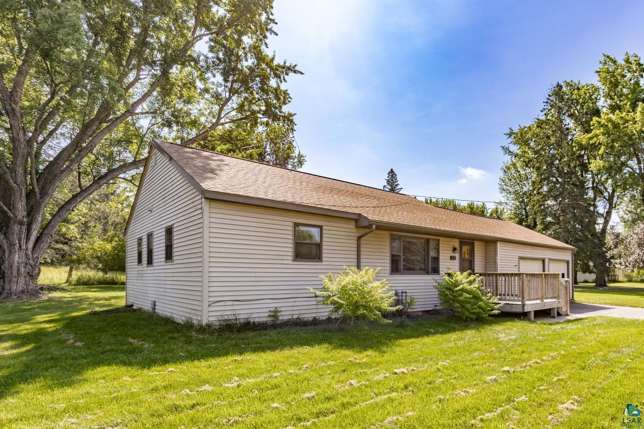 3754 Carlton Street Barnum, MN 55707 - Photo 4 of 52 View of front facade featuring roof with shingles, a front lawn, a garage, and a wooden deck