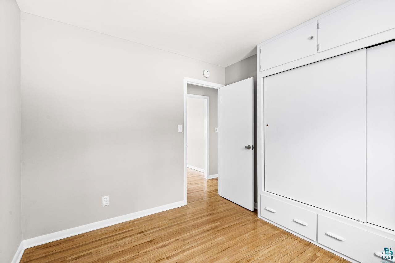 3754 Carlton Street Barnum, MN 55707 - Photo 42 of 52 Unfurnished bedroom with light wood-style floors and a closet
