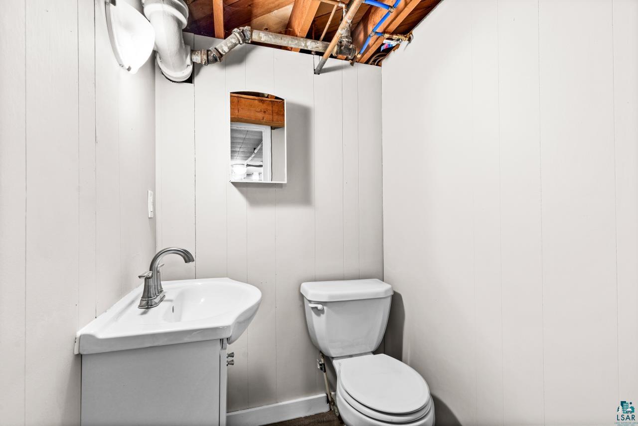 3754 Carlton Street Barnum, MN 55707 - Photo 44 of 52 Bathroom featuring vanity and wooden walls