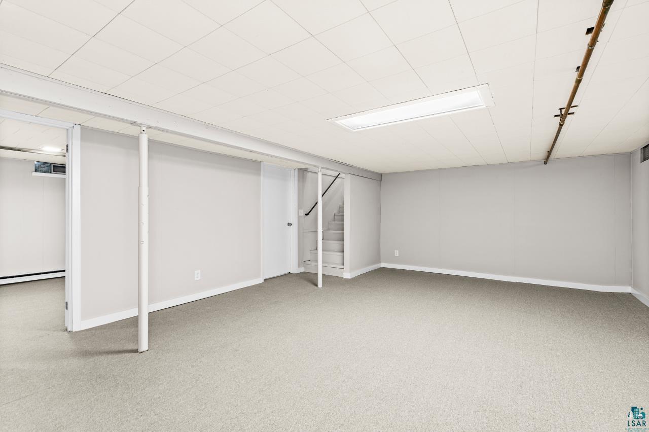 3754 Carlton Street Barnum, MN 55707 - Photo 45 of 52 Finished basement with light colored carpet and baseboards