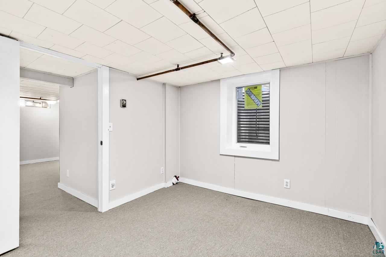 3754 Carlton Street Barnum, MN 55707 - Photo 47 of 52 Finished basement with carpet flooring and baseboards