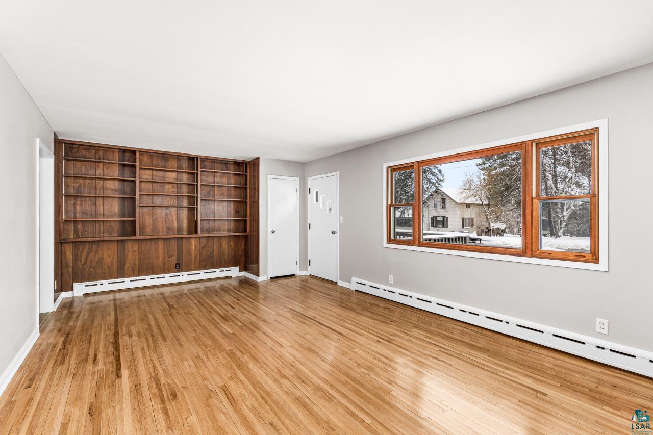 3754 Carlton Street Barnum, MN 55707 - Photo 10 of 52 Unfurnished living room featuring a baseboard radiator and light wood-type flooring