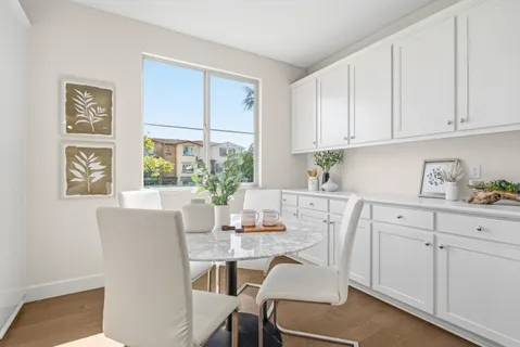 a kitchen with stainless steel appliances white cabinets and a window