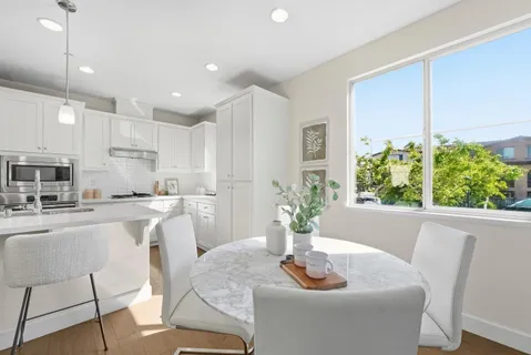 a kitchen with a table and chairs in it