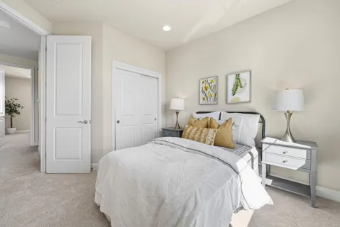 a bed room with a bed and a night stand