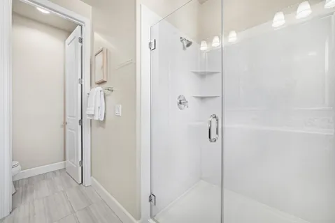 a bathroom with a glass shower door