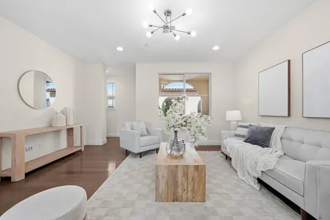 a living room with furniture and a chandelier