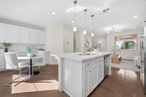 a kitchen with a sink cabinets and window