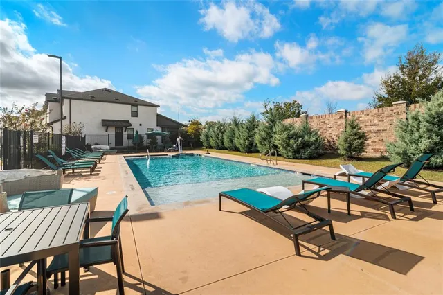 a view of a water fountain with a bench in the patio
