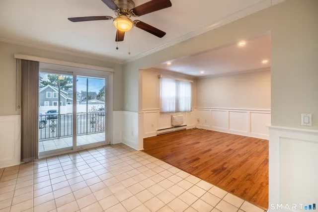 a view of a kitchen with refrigerator and cabinets
