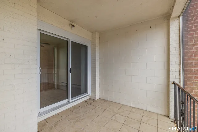 an empty room with windows and a ceiling fan