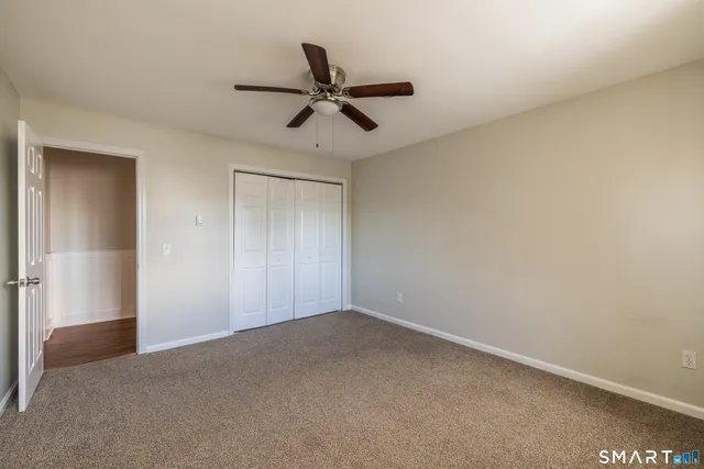 a bathroom with a sink a toilet a mirror and shower