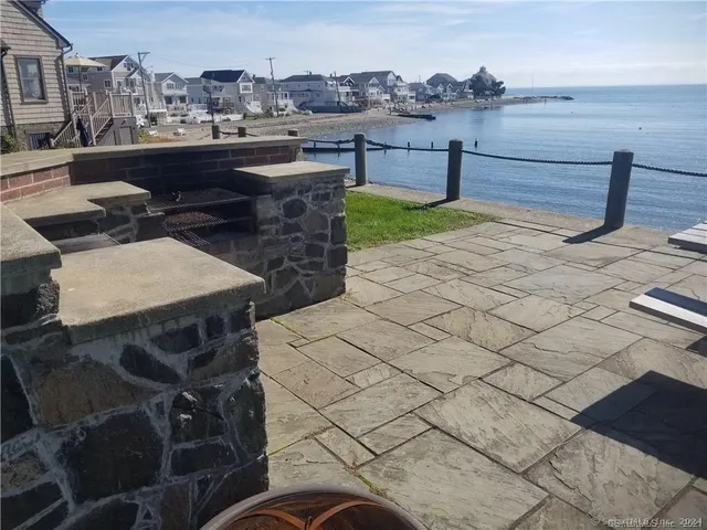 a view of empty room with window and refrigerator