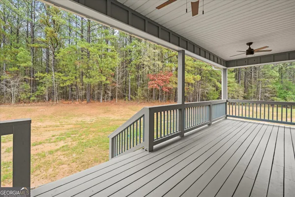 a view of outdoor space with wooden floor and windows