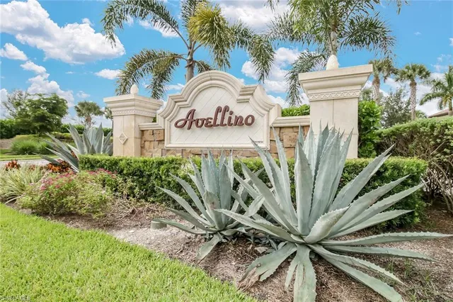 a view of a sign in a yard with potted plants