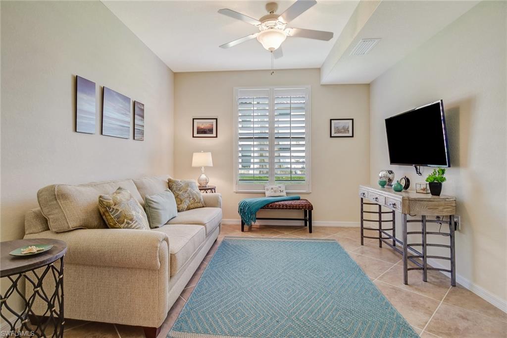9514 Avellino Way, Unit 2116 Naples, FL 34113 - Photo 13 of 30 a living room with furniture and a flat screen tv