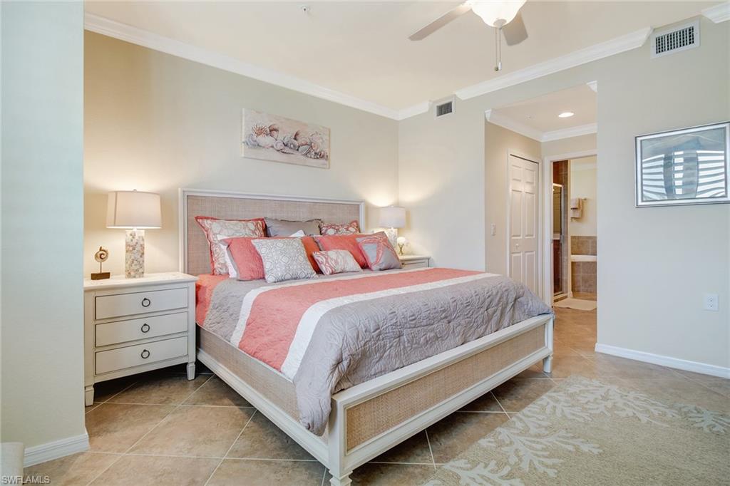 9514 Avellino Way, Unit 2116 Naples, FL 34113 - Photo 15 of 30 a bed room with a bed and a night stand