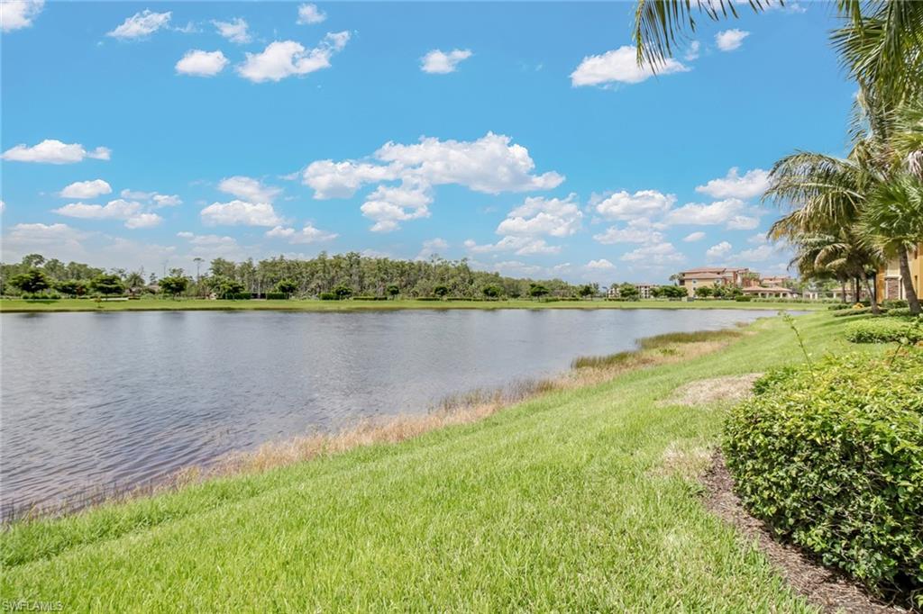 9514 Avellino Way, Unit 2116 Naples, FL 34113 - Photo 21 of 30 a view of a lake with houses in the back