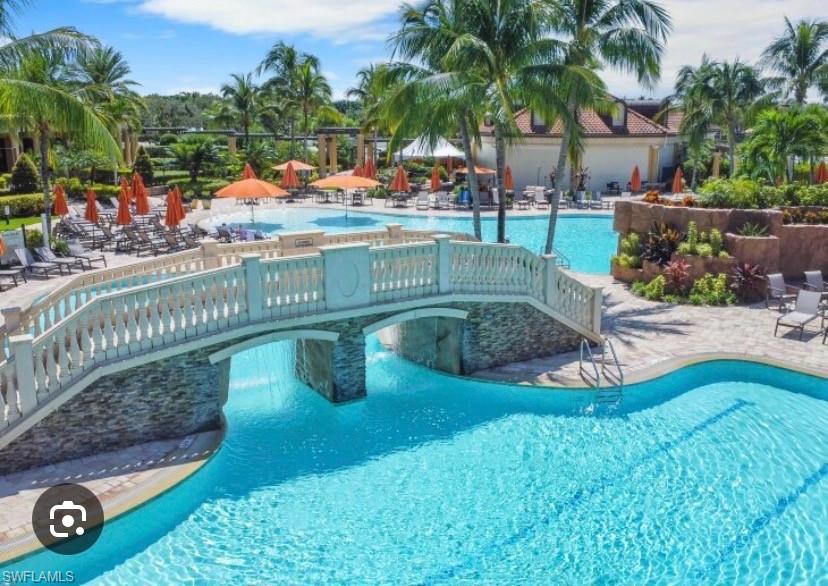 9514 Avellino Way, Unit 2116 Naples, FL 34113 - Photo 24 of 28 a view of a swimming pool with a yard