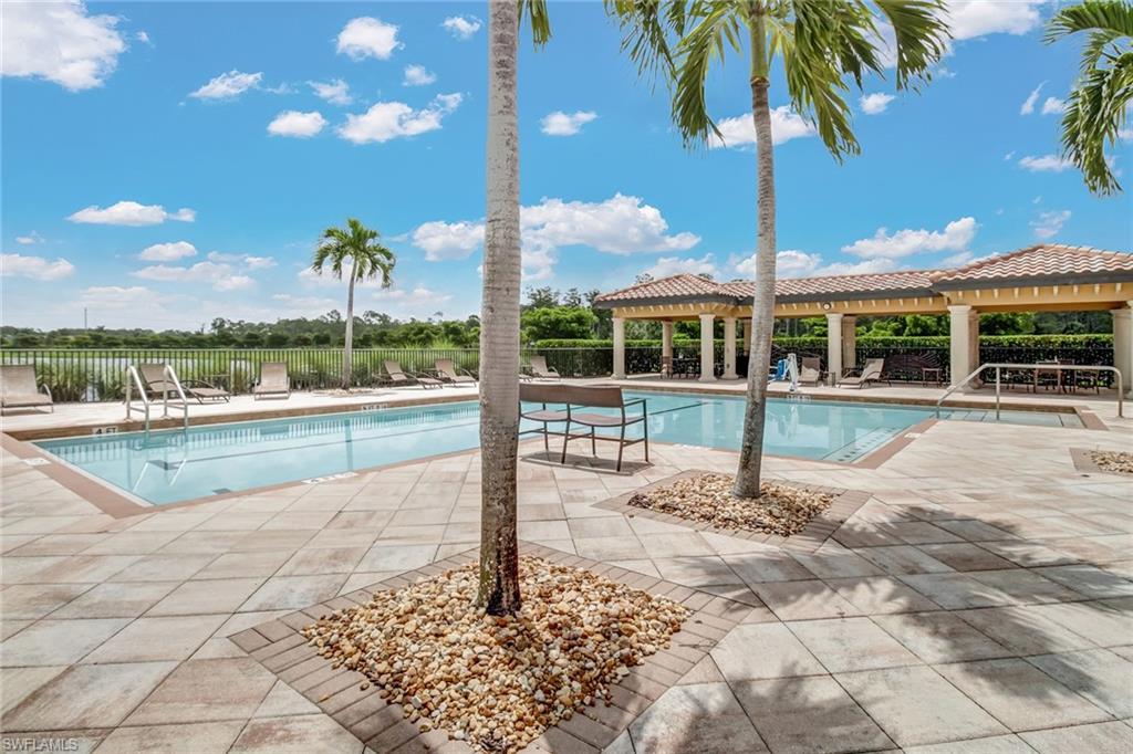9514 Avellino Way, Unit 2116 Naples, FL 34113 - Photo 28 of 30 a view of a house with a swimming pool and sitting area