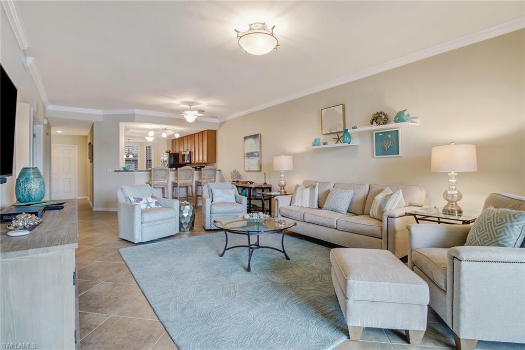9514 Avellino Way, Unit 2116 Naples, FL 34113 - Photo 5 of 30 a living room with furniture and a flat screen tv
