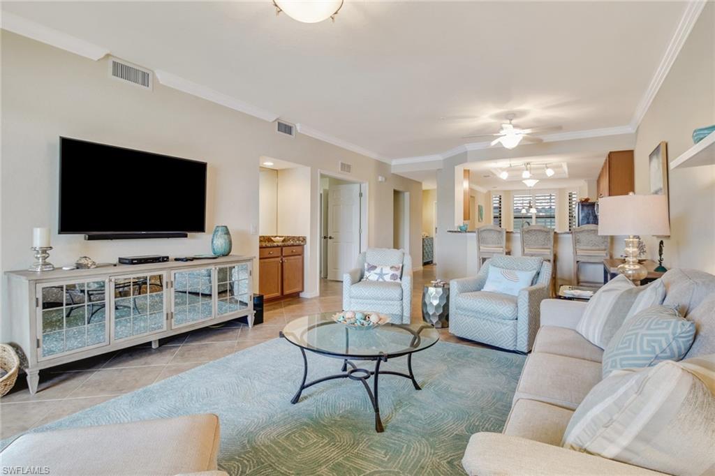 9514 Avellino Way, Unit 2116 Naples, FL 34113 - Photo 6 of 30 a living room with furniture and a flat screen tv