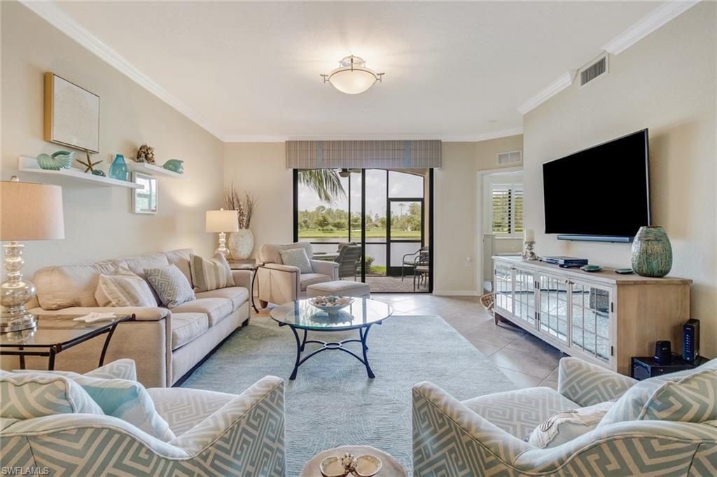 9514 Avellino Way, Unit 2116 Naples, FL 34113 - Photo 7 of 30 a living room with furniture and a flat screen tv