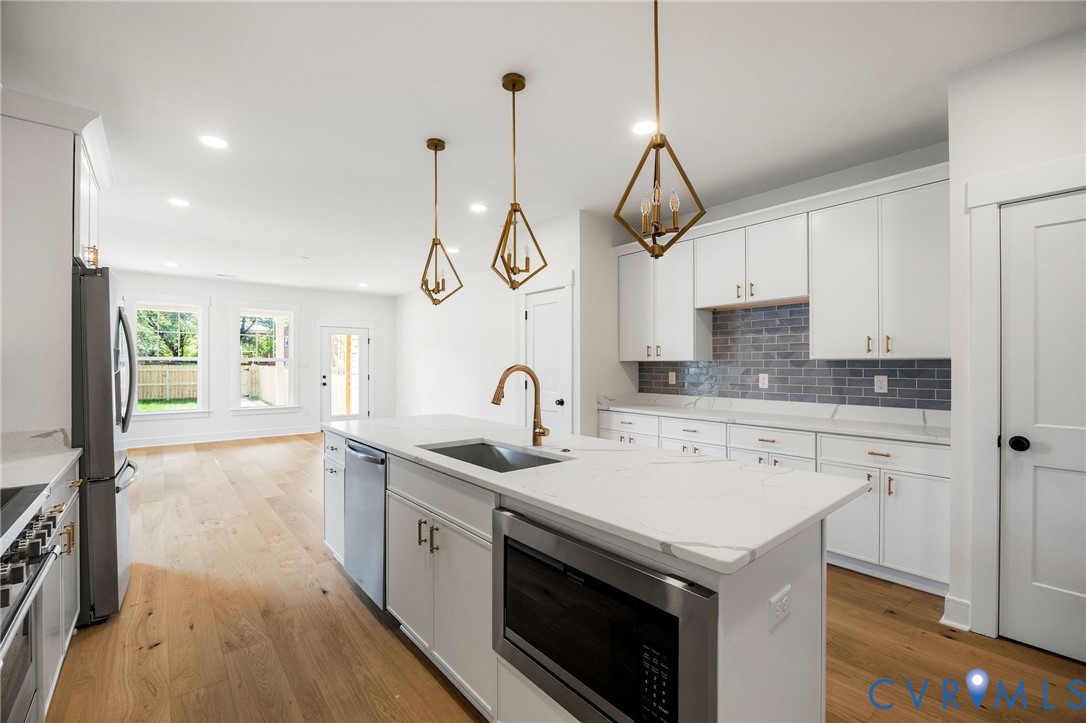 3423 Stuart Avenue Richmond, VA 23221 - Photo 13 of 34 a kitchen with a sink a stove and cabinets