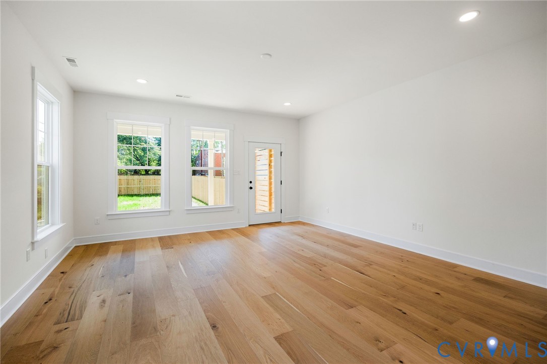 3423 Stuart Avenue Richmond, VA 23221 - Photo 16 of 34 a view of an empty room with wooden floor and a window
