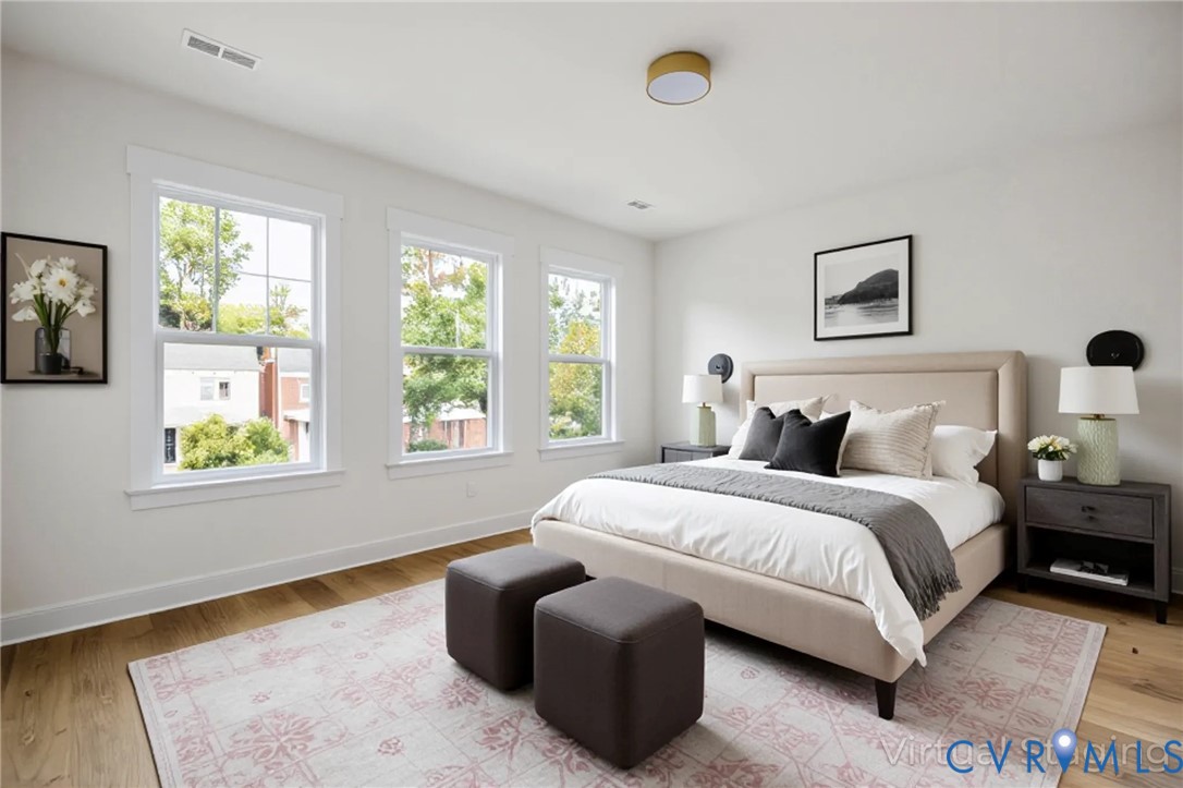 3423 Stuart Avenue Richmond, VA 23221 - Photo 20 of 34 a spacious bedroom with a bed and window