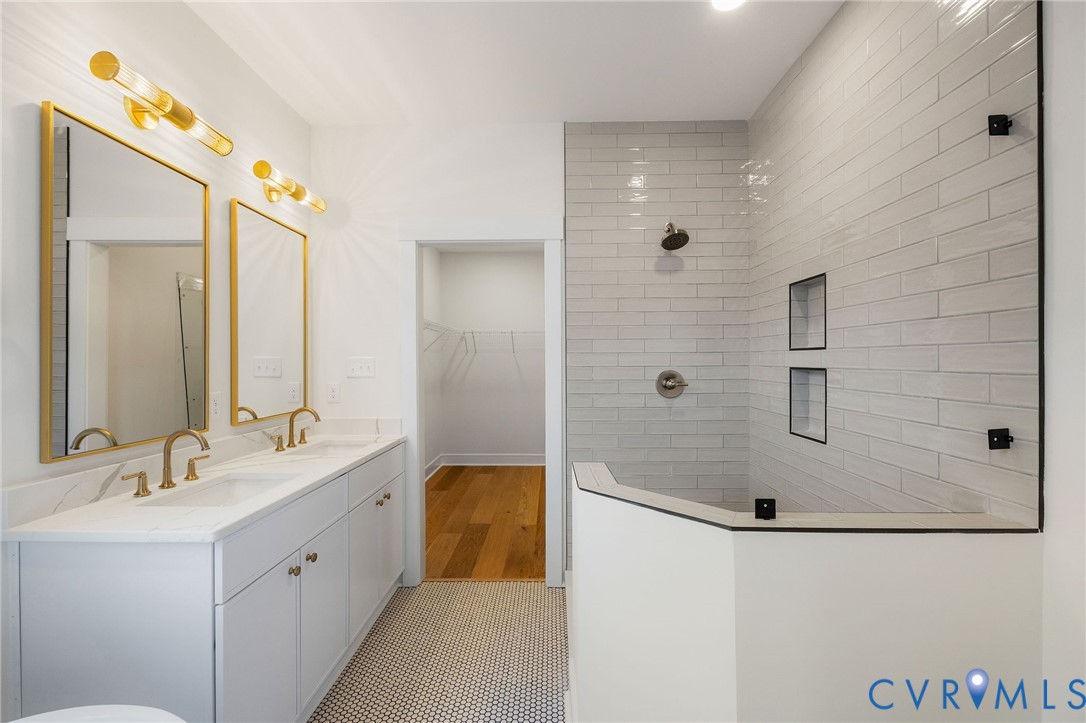 3423 Stuart Avenue Richmond, VA 23221 - Photo 25 of 34 a bathroom with a double vanity sink mirror and shower